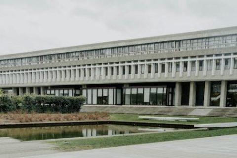 View of Simon Fraser University's Brutalist architecture with a reflecting pond in Burnaby, Canada.